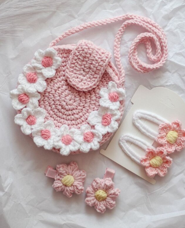 handmade crochet set includes a pink daisy-adorned sling bag and matching flower hair clips